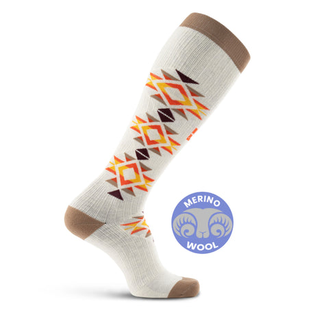 Mesa Horizon tall compression socks with geometric orange and brown pattern on cream base, brown cuff and heel, Merino Wool badge visible