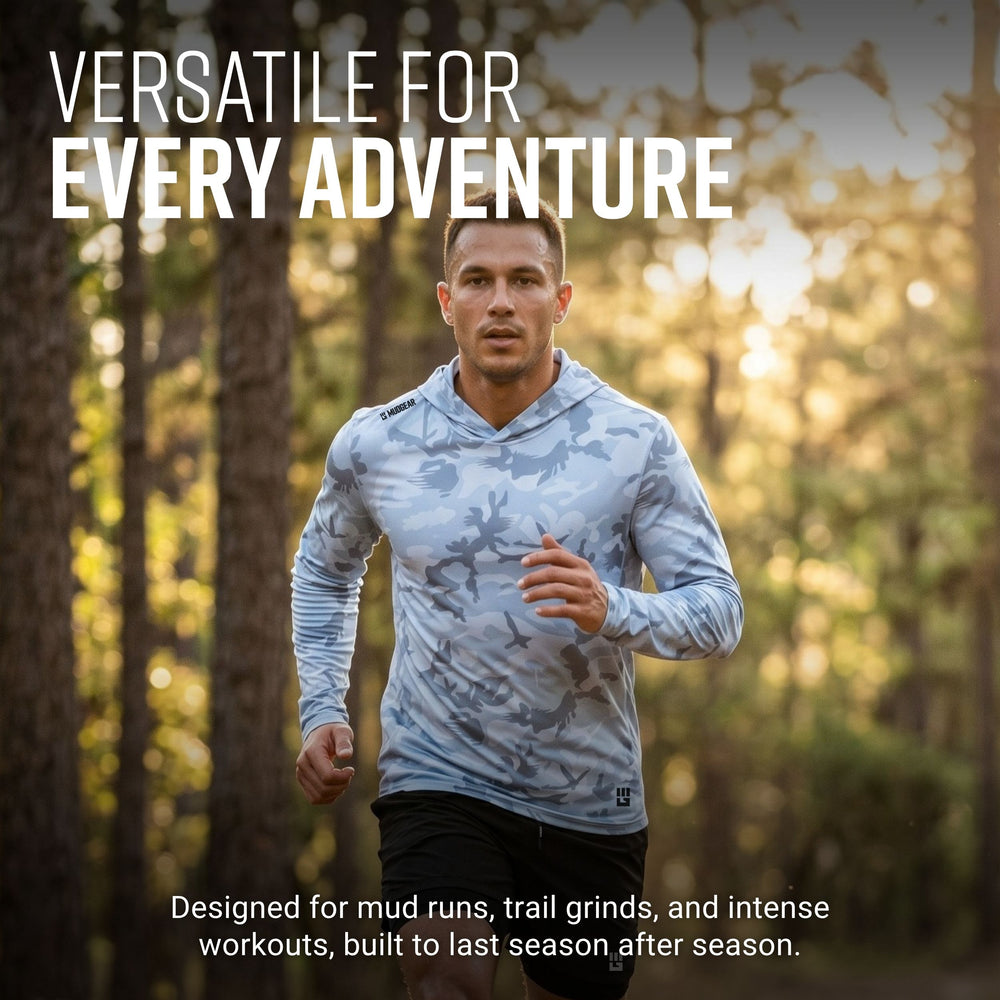Man running on forest trail wearing light gray camo MudGear Sun Hoodie