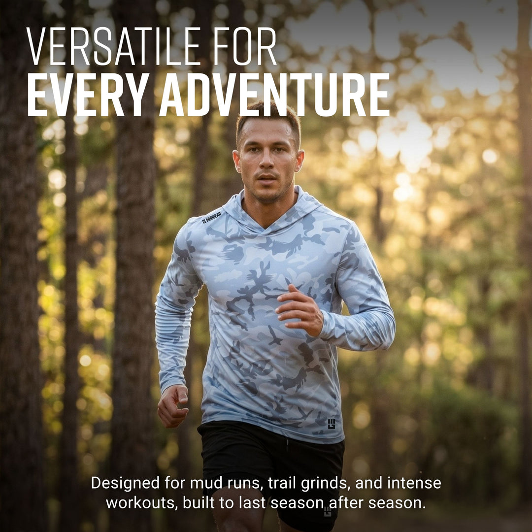 Man running on forest trail wearing light gray camo MudGear Sun Hoodie